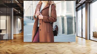 Stylish fashionable blonde woman wearing coat and sunglasses, street style photo Wall mural