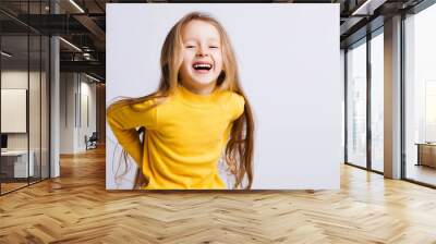 Cute girl 4-5 year old posing in studio. Original, square photo with space for text. Wall mural