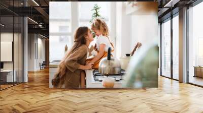 Two sisters play in a bright, stylish kitchen. Beautiful interior. Wall mural