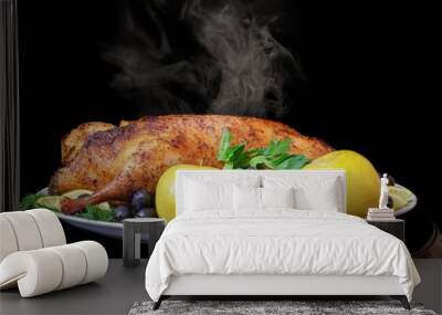 Roast duck with apples, lemon, olives and herbs on a black background Wall mural