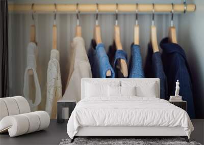 Clothes on hangers in the cabinet gradient from white to dark blue Wall mural