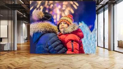 happy family looking fireworks in the evening sky. fireworks new year, christmas. Crazy 2020 is over, it's 2021 Wall mural