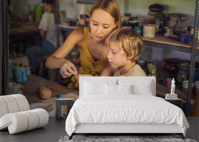 mother and son doing ceramic pot in pottery workshop Wall mural