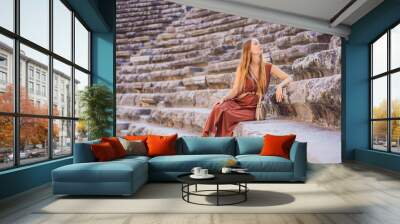 Woman tourist explores Aspendos Ancient City. Aspendos acropolis city ruins, cisterns, aqueducts and old temple. Aspendos Antalya Turkey. turkiye Wall mural