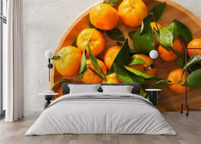 Plate of fresh and juicy tangerines with leaves on a white stone background. Top view and copy space. Wall mural