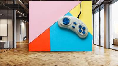 Retro joystick on a coloful paper background. Top view. Wall mural