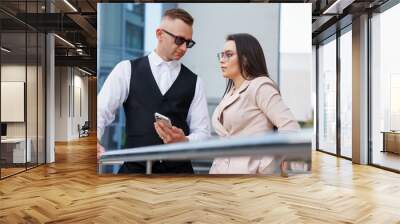 Stylish Business Attire: A Modern Couple Engaged in Conversation Wall mural