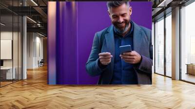 man with phone on purple background Wall mural