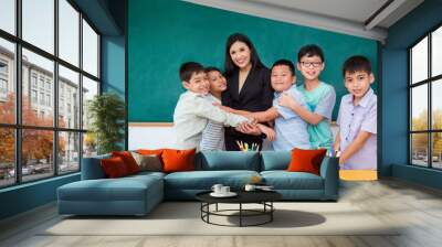 Group of asian student hugging their teacher in classroom Wall mural