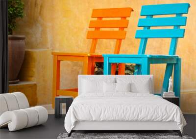 two colorful chairs in the garden Wall mural