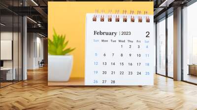 Close up the February 2023 Monthly desk calendar for 2023 year on yellow background. Wall mural