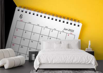 June 2022 desk calendar on yellow and black background. Wall mural