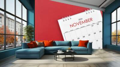 November 2024 desk calendar on red background. Wall mural