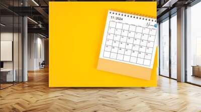 November 2024 desk calendar on yellow color background. Wall mural