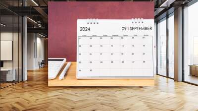 September 2024 white calendar and calculator with pen. Wall mural