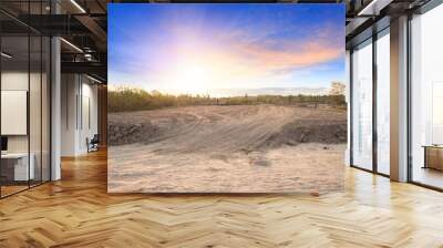 Empty dry cracked swamp reclamation soil, land plot for housing construction project with car tire print in rural area and beautiful blue sky with fresh air Land for sales landscape concept Wall mural