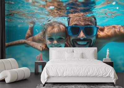 Father & daughter swimming underwater in a pool on summer vacation. Googles water action shot. Happy family on holiday. Learning to swim. Blue Father's day banner concept  Wall mural