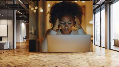 Woman experiencing a headache while working on laptop, stressed and frustrated  Wall mural