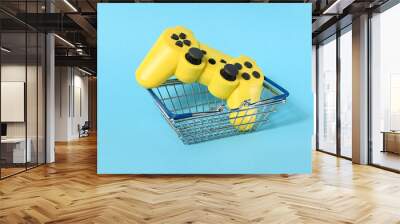 A small food basket with game control on a blue background. Wall mural