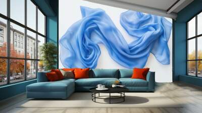 A flowing light blue silk scarf elegantly draped on a plain white background Wall mural