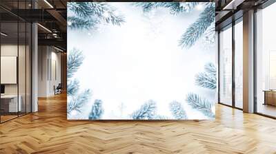 Frosted pine branches and snowflakes creating a beautiful winter frame on a white background Wall mural