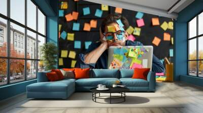 Overwhelmed businessman at cluttered desk with sticky notes and laptop Wall mural