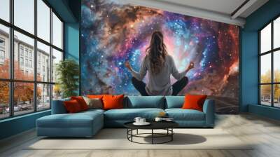 Woman meditating in a cosmic setting, stars and nebula surrounding her in a serene universe Wall mural