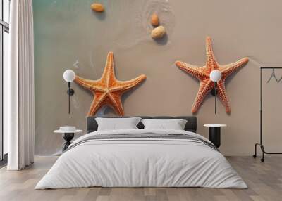 Two starfish on the beach, on the sea sand, view from above. Wall mural