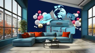 A suitcase under the globe surrounded by a camera and hat on an blue background.-3d rendering. Wall mural