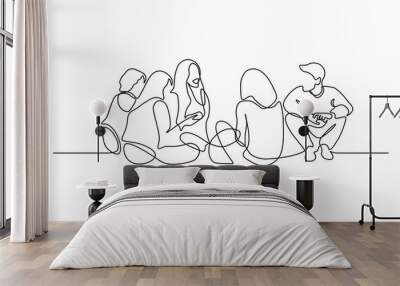 Group of young people sitting on ground together and talking. Friends rest and communicate. Continuous line art drawing style. Minimalist black linear sketch on white background. Vector illustration Wall mural