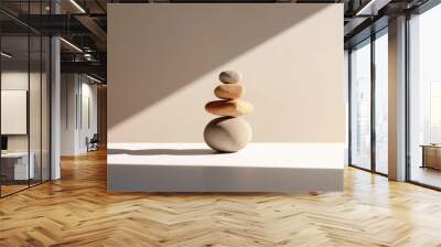 Zen stone composition on a beige background with shadow and sunlight. Balanced stacks of stones evoke tranquility and meditative state. Neutral tones enhance the sense of calmness. Copy space Wall mural