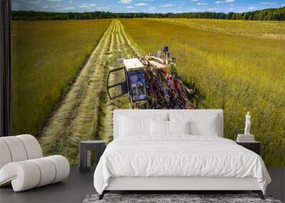 Farmers using combines harvesting this years flax crop which has many uses. Wall mural