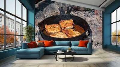 Bannock - fry bread in the pan on hot coals Wall mural