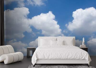 Clear blue sky background with white fluffy clouds. Wall mural