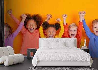 Joyful children dancing in vibrant orange room, celebrating with raised arms Wall mural