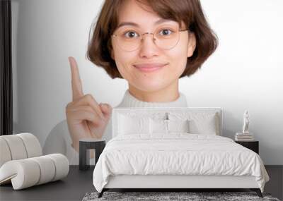 Spanish Chinese woman over isolated white background pointing finger to the side Wall mural