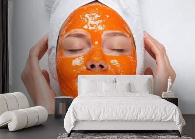 Young woman with papaya facial mask isolated on white background, skincare concept. Wall mural