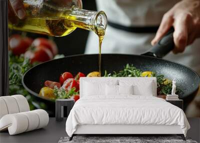 Chef pouring olive oil onto a colorful vegetable stir-fry Wall mural