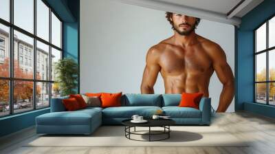 Handsome muscular man with a beard posing in swim trunks Wall mural