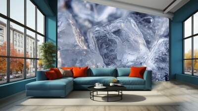 Ice cubes melting on blue surface with water droplets Wall mural