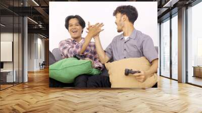 Asian young friends play video games together at home, celebrating victory of winning games Wall mural