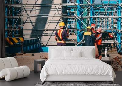 Group of construction worker with helmet working together at construction site Wall mural