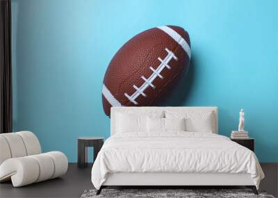 Mini rugby ball isolated on a blue background. Minimalism Sport concept with copy space. Wall mural