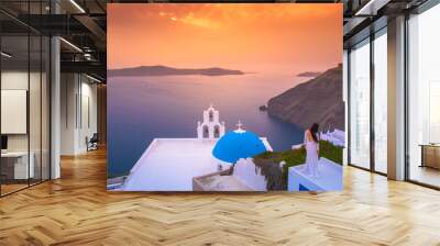 Brilliant sunset at Fira with a church and a bride on a roof, Santorini, Greece. Wall mural