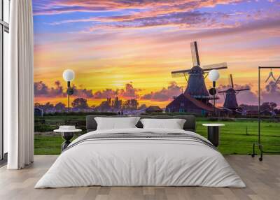 Traditional village with dutch windmills and river at sunset, Holland, Netherlands. Wall mural