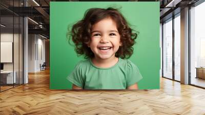 Studio portrait of cuttle little laughing girl on different colours background Wall mural