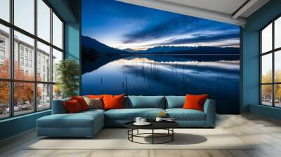 Wide angle shot of reflections of mountains and sky on pristine waters of Rara Lake during blue hour at dawn. Rara Lake in Mugu is the largest lake of Nepal. Wall mural