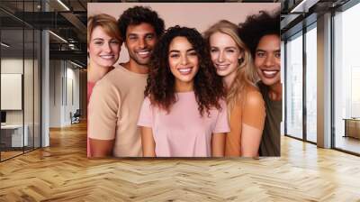 Group of diverse, smiling young adults standing in a row against a neutral background. Wall mural