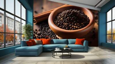 High-resolution close-up of black peppercorns in a bowl on a wooden table, alongside a pile of ground black pepper, capturing the vibrant, earthy essence of this essential spice Wall mural