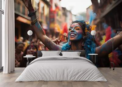 Joyful woman with blue-painted face celebrating at a vibrant street festival, surrounded by colorful powder and happy people. Wall mural